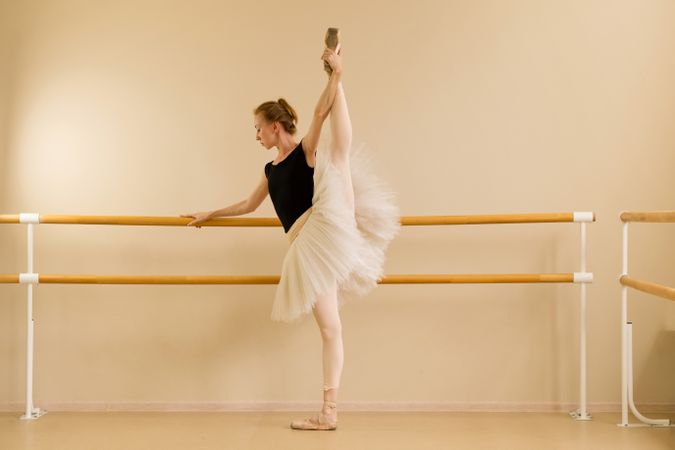Ballet dancer maintaining high leg stretch