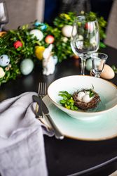 Delicate decorative nest in bowl for spring table setting