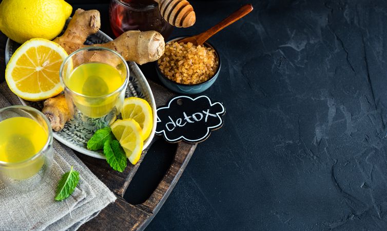 Yellow detox drinks with ginger, lemon and honey with copy space