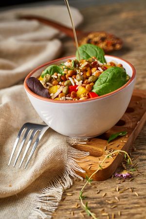 Bright vegetables with lentils and spinach in bowl