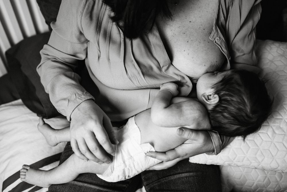 Mom breastfeeding at home