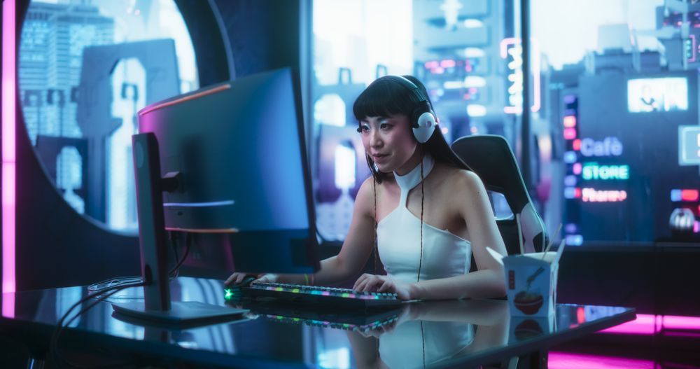 Stylish Streamer or Video Gamer Playing Games and Chatting with Internet Subscribers in a Futuristic Neon Room