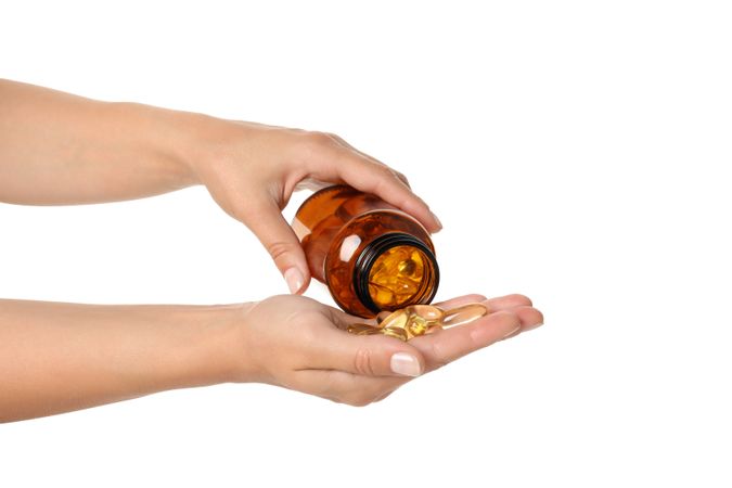 Brown bottle with omega pills, isolated on blank background