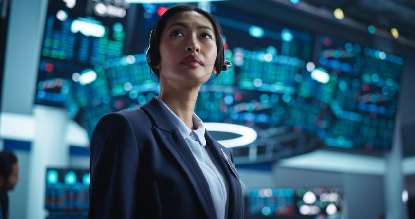 Successful Stock Exchange Manager Wearing Headphones, Working in Modern Office.