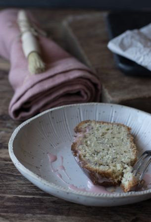 Delicious orange cake with poppy seeds and creme on plate