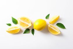 Flat lay composition with lemons on plain background, space for text