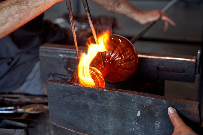 Crop man with burning fire forming vase