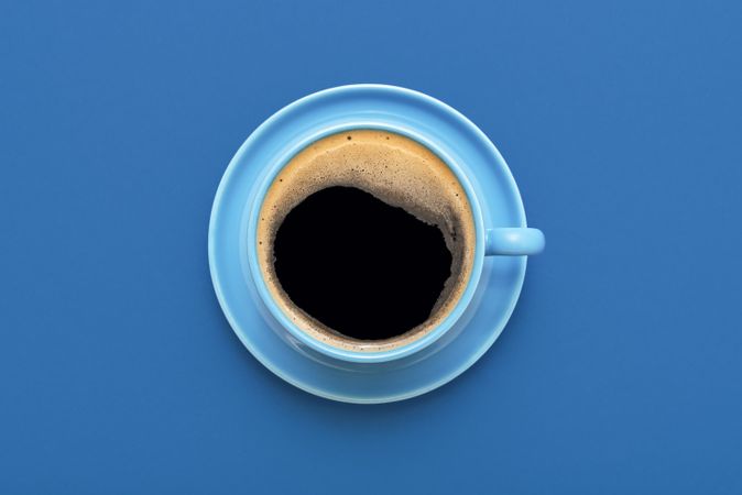 Cup of coffee minimalist on a blue background