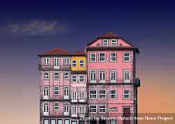 Gradient pink and purple European building against a blue and peach sky 0gxp75