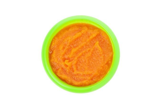 Bowl with healthy baby food isolated on plain background