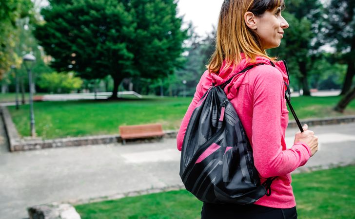 Sportswoman with backpack going to the gym