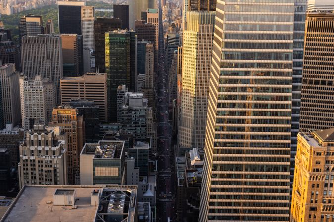 Helicopter Tour of New York City Architecture at Night. Fly-By Over Manhattan with Panorama of Office Buildings with Lights and Congested Streets with Cars and Taxi Vehicles