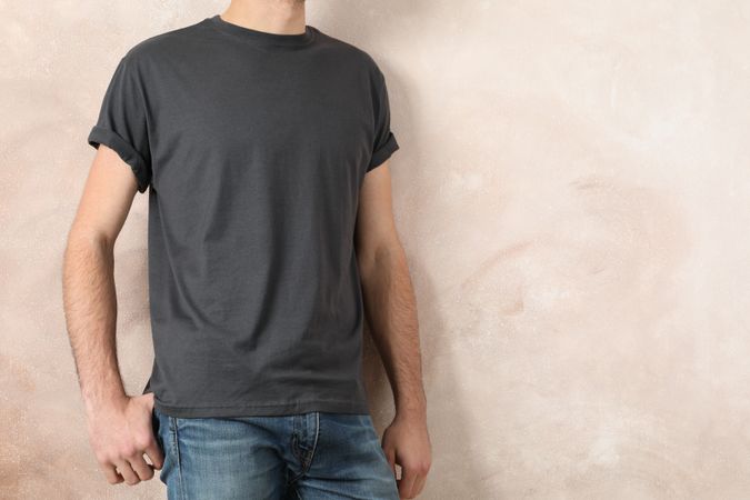 Men in blank grey t-shirt against color background, space for text