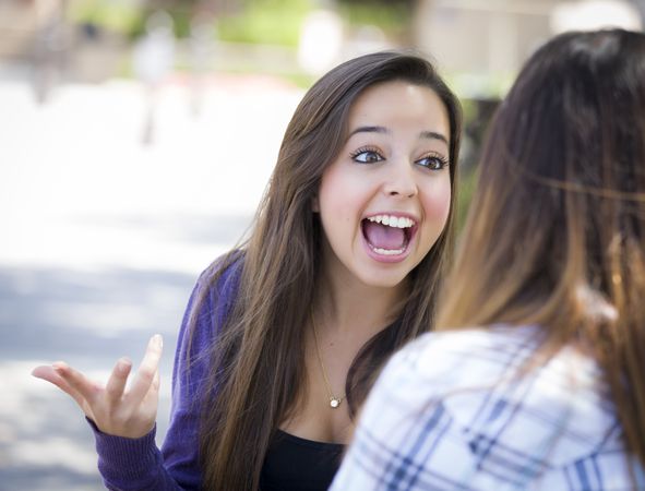 Expressive Female Sitting and Talking with Friend