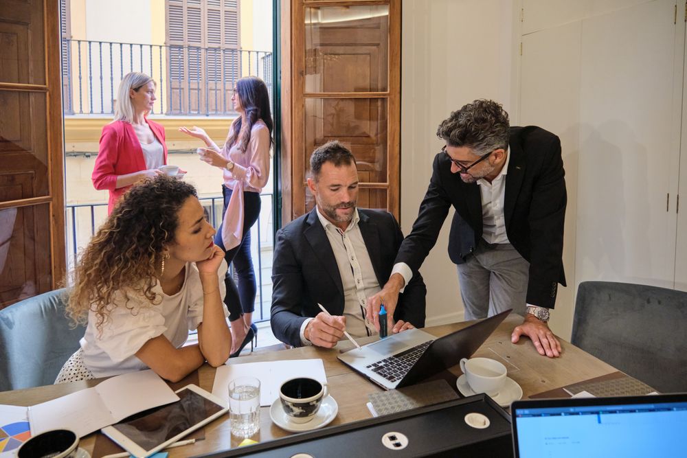 Colleagues talking about work in office