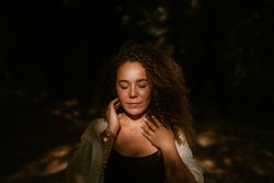 Smiling woman standing in forest