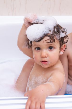 Funny baby taking a bath