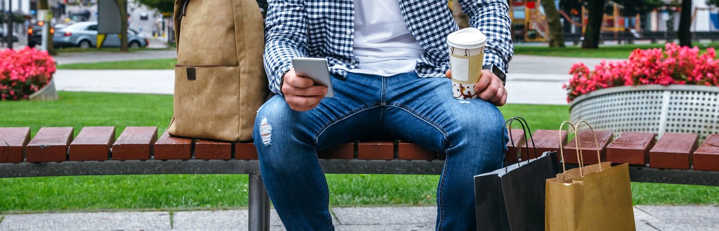 Man with mobile looking camera