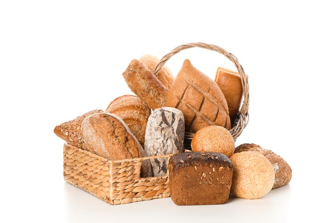 Bakery products in straw basket isolated on blank background