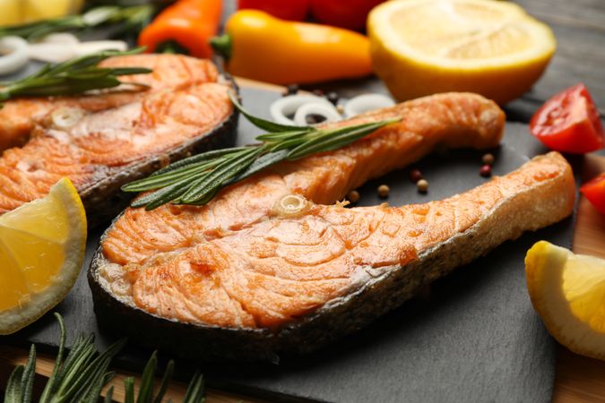 Composition with tasty grilled salmon on wooden background, close up