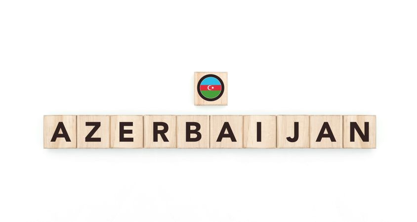 Wooden blocks bearing the name and flag of Azerbaijan. Azerbaijani and Asian Culture, national identity, travel, and geography in a copy space design.
