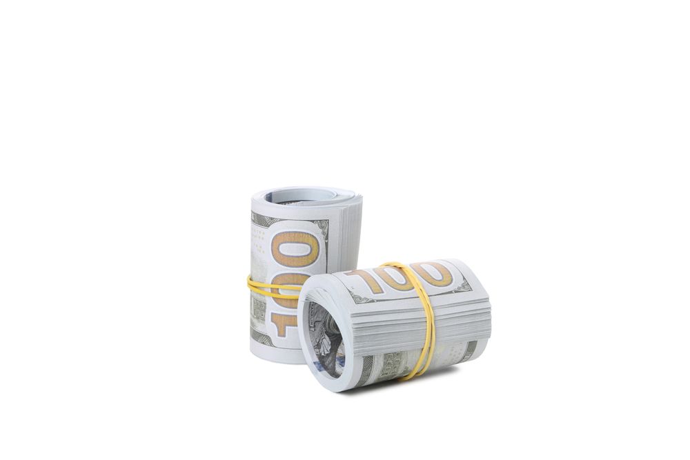 Stacks of American cash money, isolated on light background