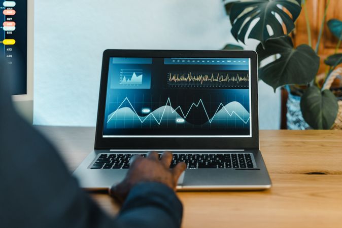 Crop Black businessman typing on laptop
