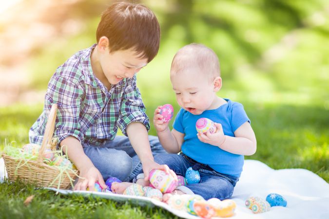 Brothers Outside in Park Playing with Easter Eggs