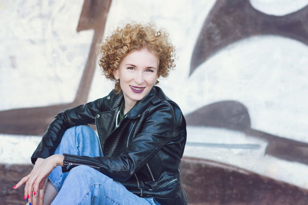 Smiling young woman with curly hairstyle