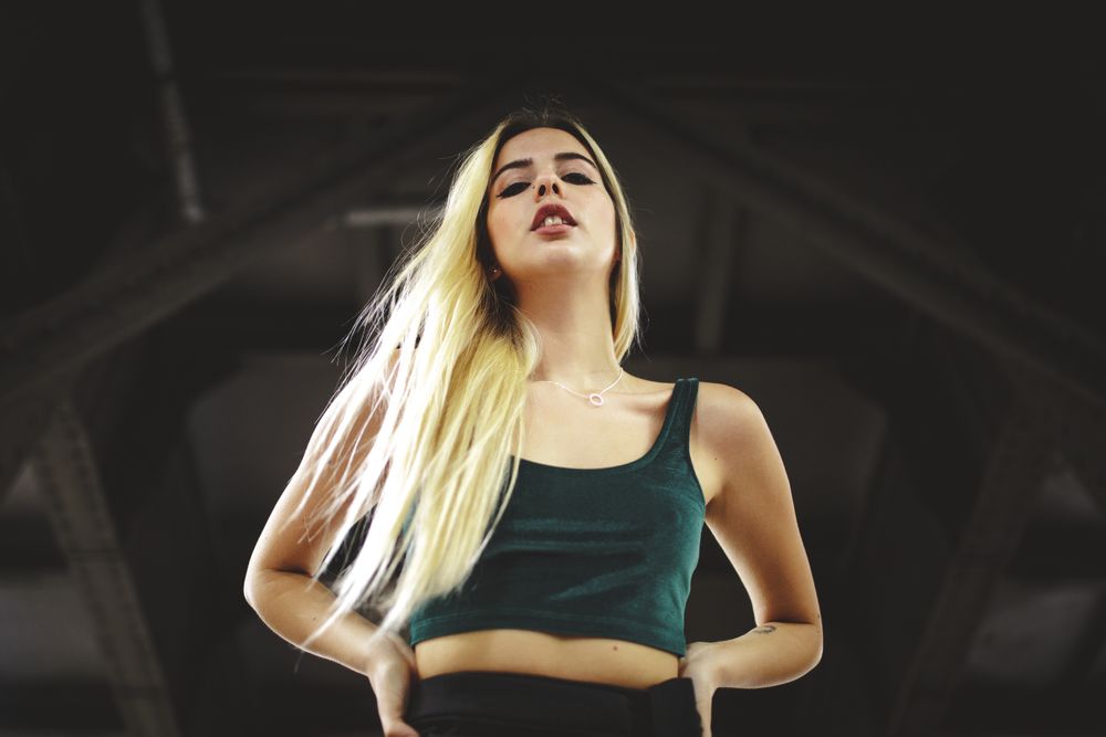 Blonde cheerful model standing and looking at camera