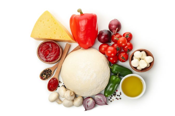 Dough and ingredients for cooking pizza isolated on blank background