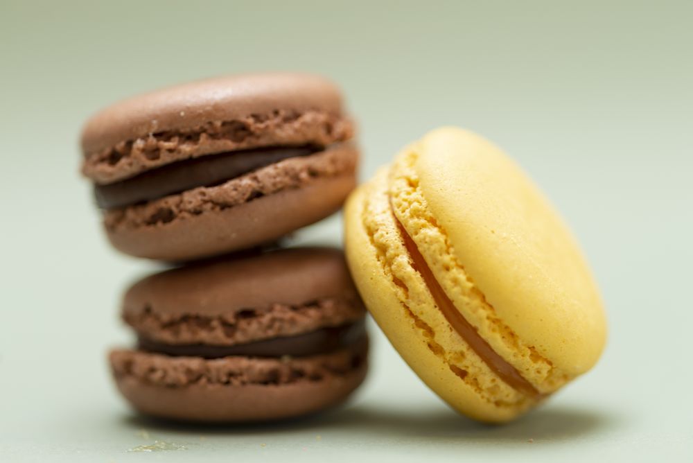 Close up of chocolate & lemon macaroons on a green table