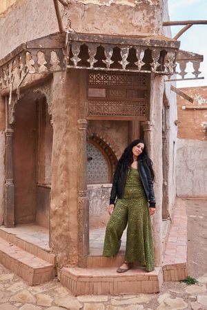 Woman on street between ancient buildings