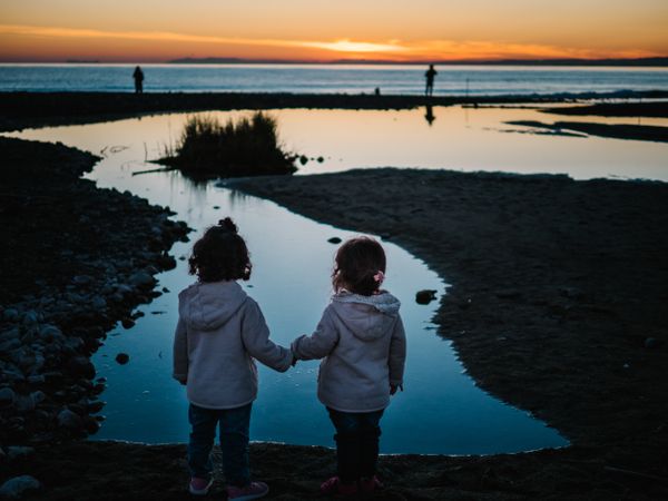 back view of little girls looking at sea
