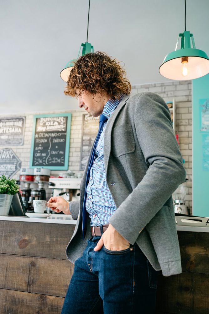 Man holding cup of coffee in a bar