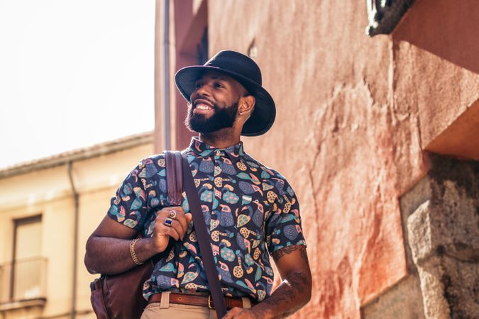 Stylish Black man walking on the city street