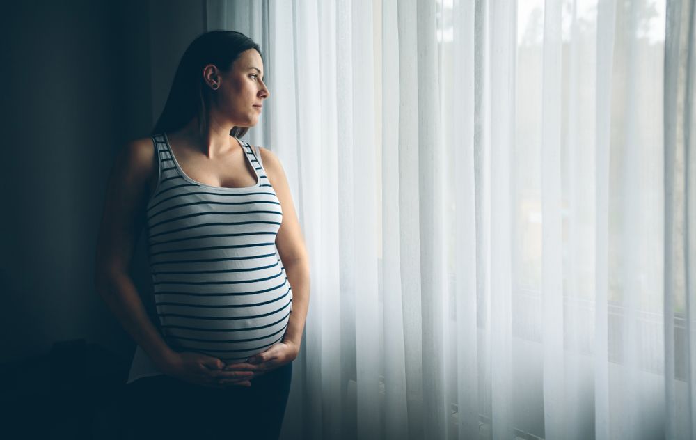 Pregnant woman holding her belly