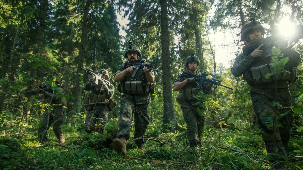 Squad of Five Fully Equipped Soldiers in Camouflage on a Reconnaissance Military Mission