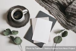 Blank greeting card, invitation mockup, dry eucalyptus tree branches, diary and linen blanket with cup of coffee 41lMWl