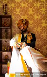 Portrait of an Indian man wearing turban and lungi indoor 5awxob
