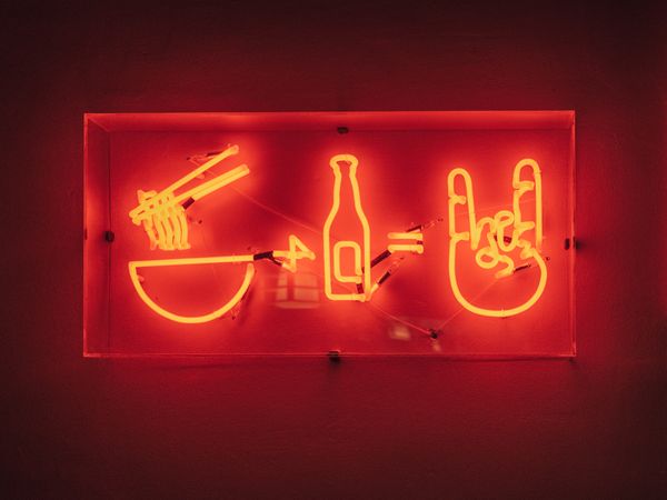 Neon signboard on red background