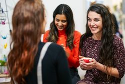 Women sipping coffee and laughing