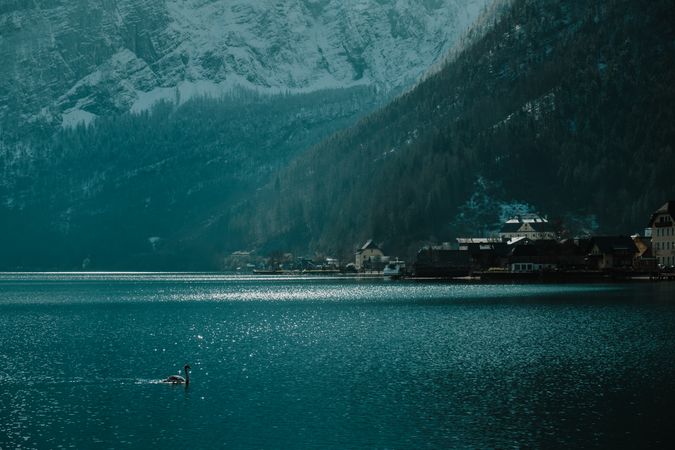 Lonely empty pier in turquoise water along mountain