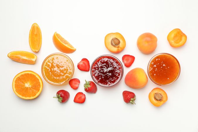 Composition with jam and ingredients on plain background, top view