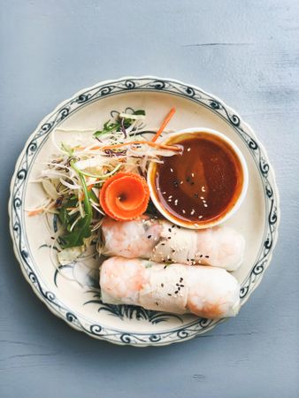 Top view of spring rolls with dipping sauce, copy space