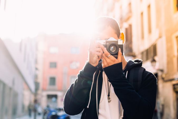 Man taking picture with camera to face