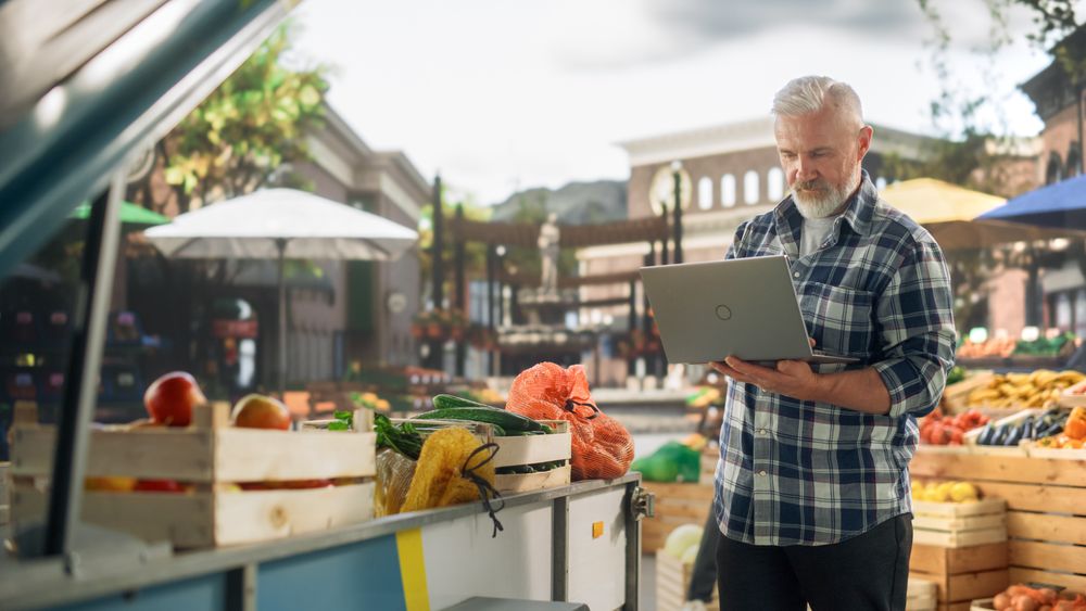 Successful Farmer Working on a Laptop Computer