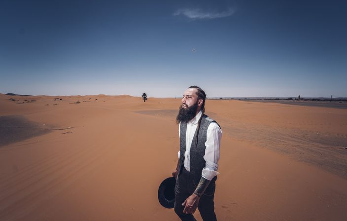 Bearded cowboy in desert