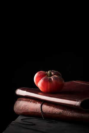 Fresh tomato on old books