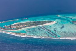 Beautiful tropical island in the Maldives with overwater bungalows and beaches